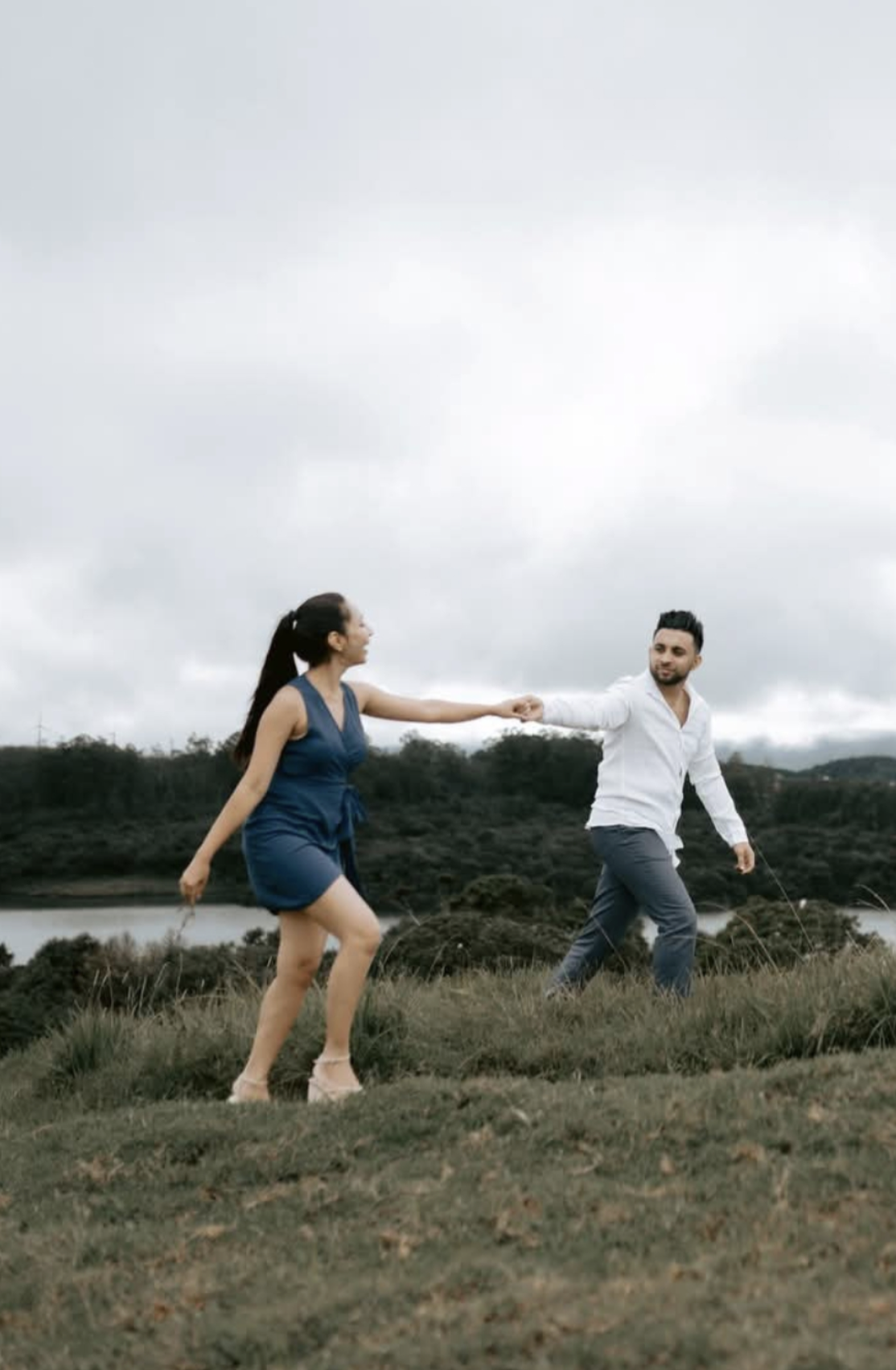 A couple walking on a beach at sunset